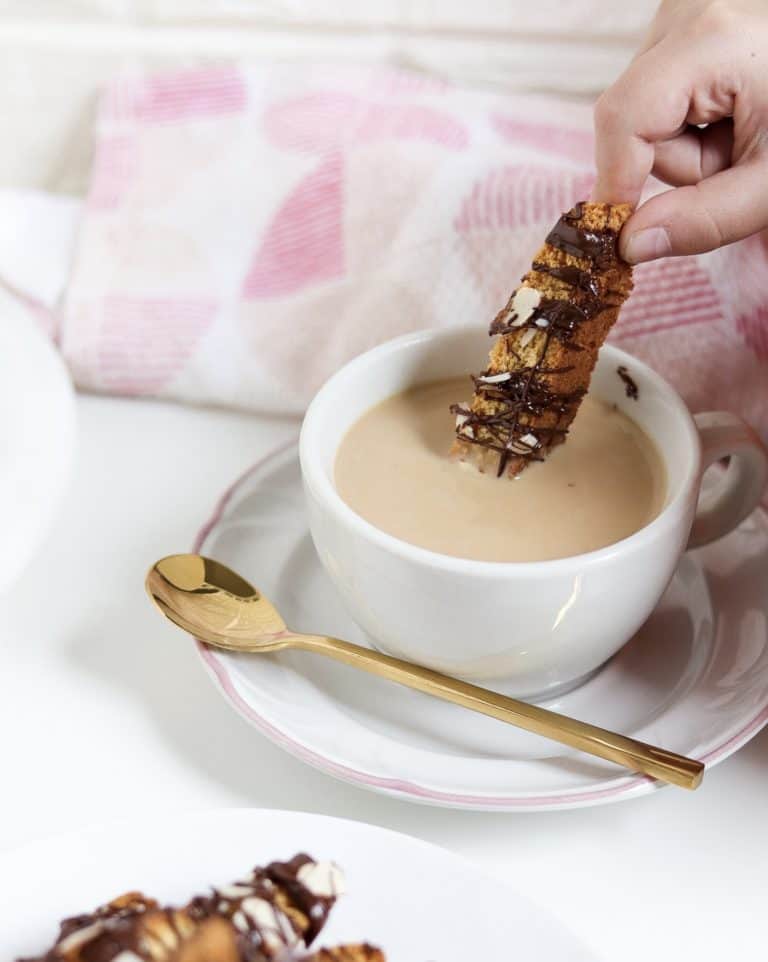 gluten free almond biscotti with chocolate drizzle in coffee