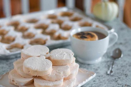 plate of pumpkin pie marshmallows next to a cup of coffee